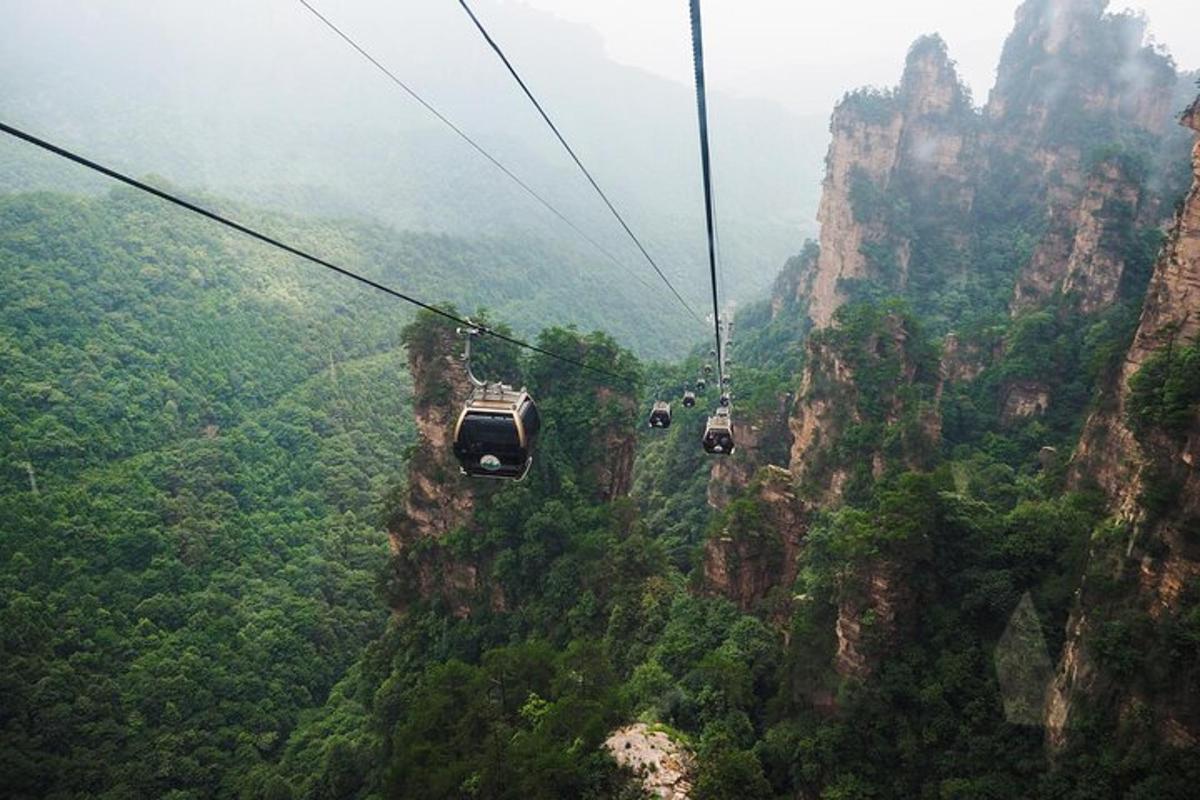 two cable cars flying over a mountain cliff