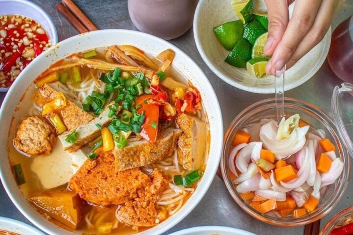 a table with a bowl of soup and bowls of food