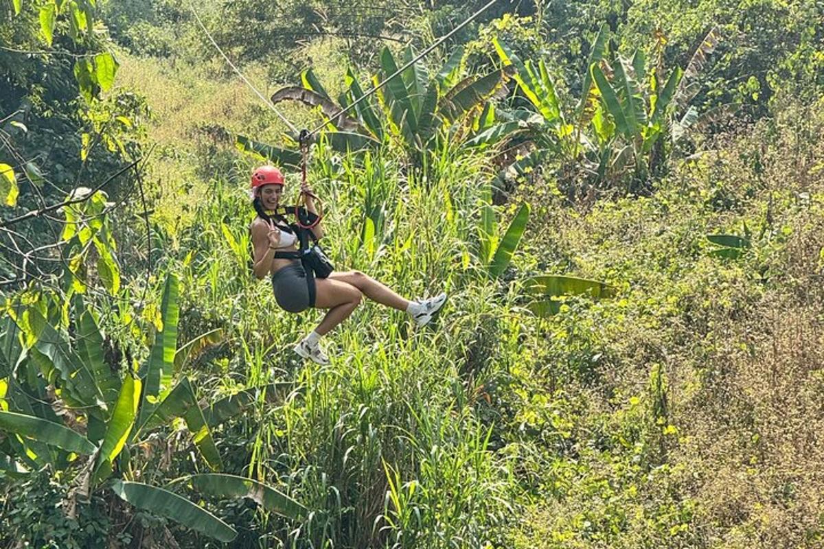 a woman is zip lining through the forest