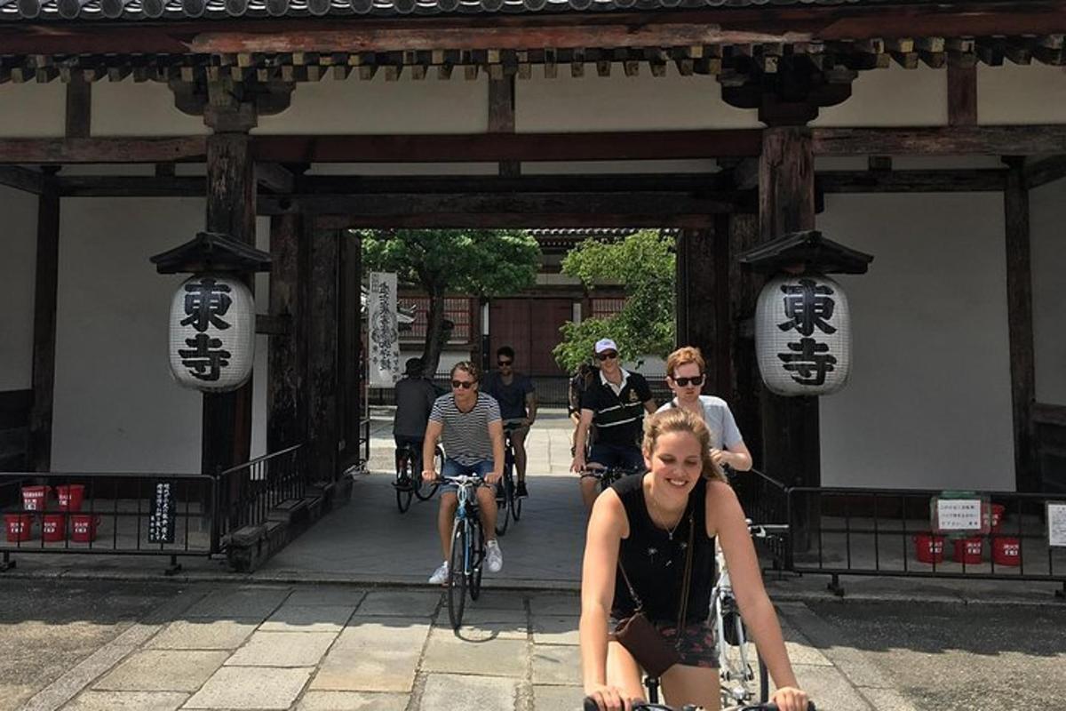 a group of people riding bikes through a gate