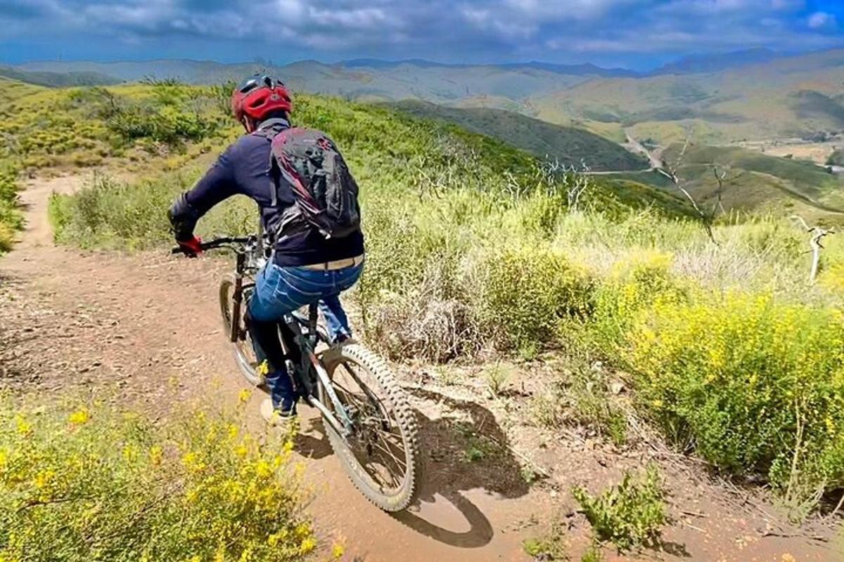 a person riding a bike on a dirt trail