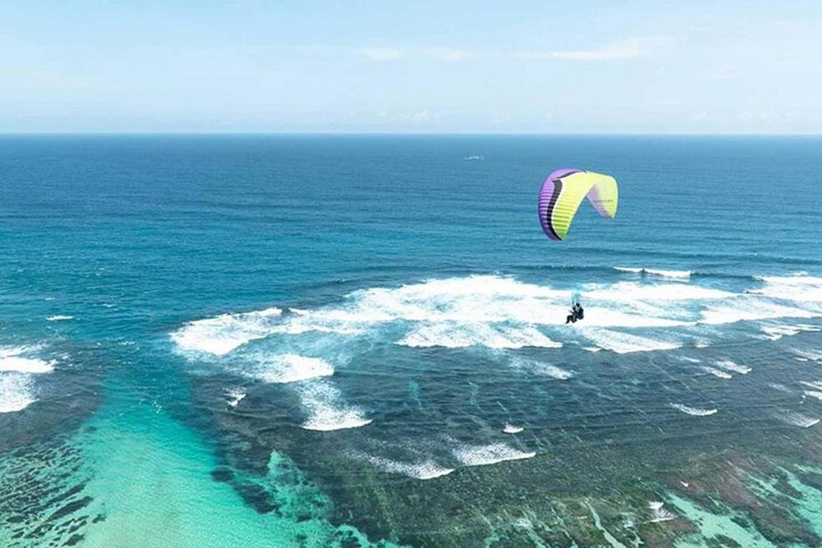a person flying a kite over the ocean