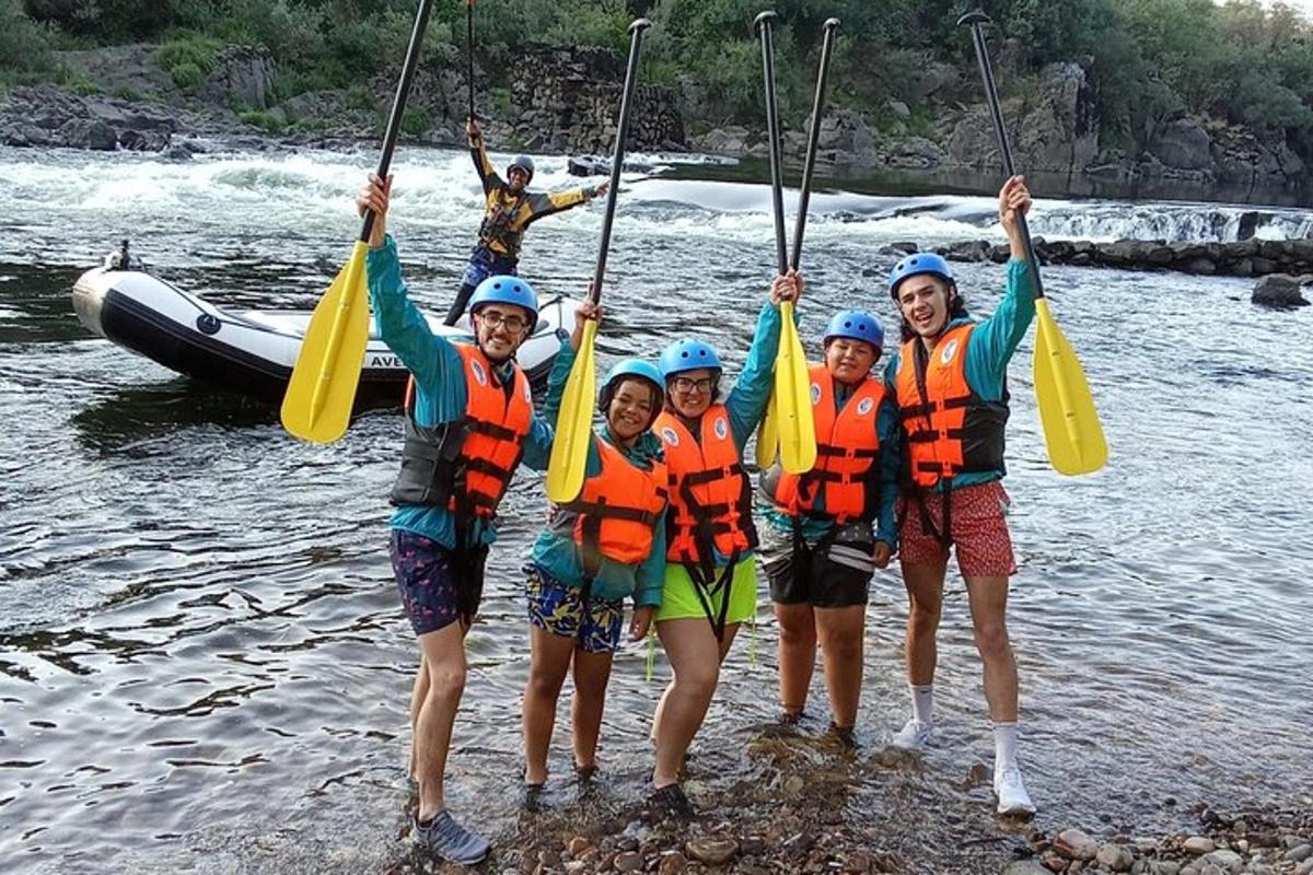 a group of people standing in the water on a river