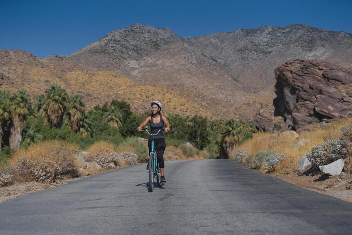 a woman riding a bike down a road