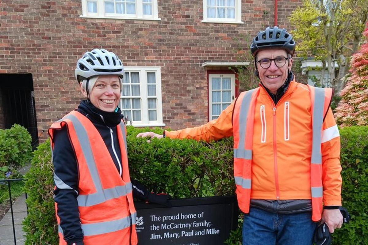 two people wearing helmets standing in front of a building