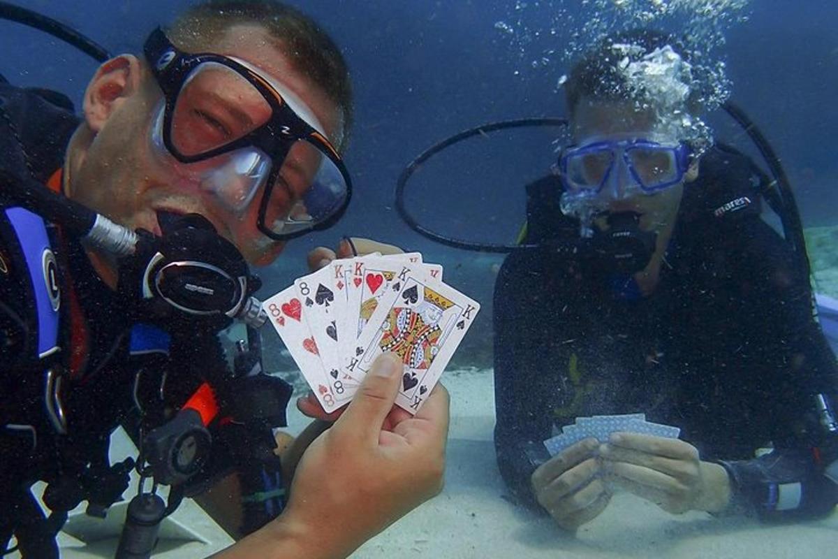 two people in the water holding playing cards