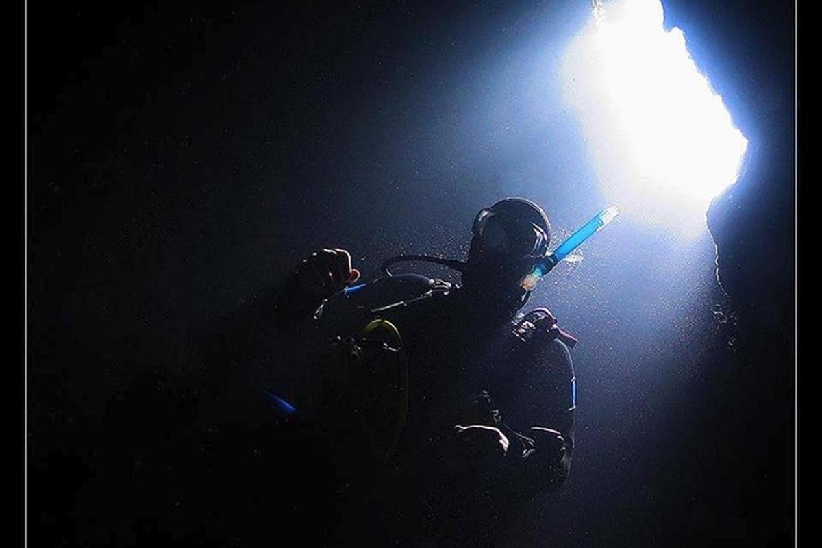 a person standing under a light in the dark