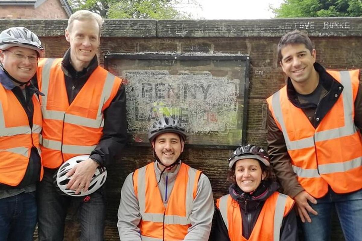 a group of men wearing safety vests standing in front of a wall