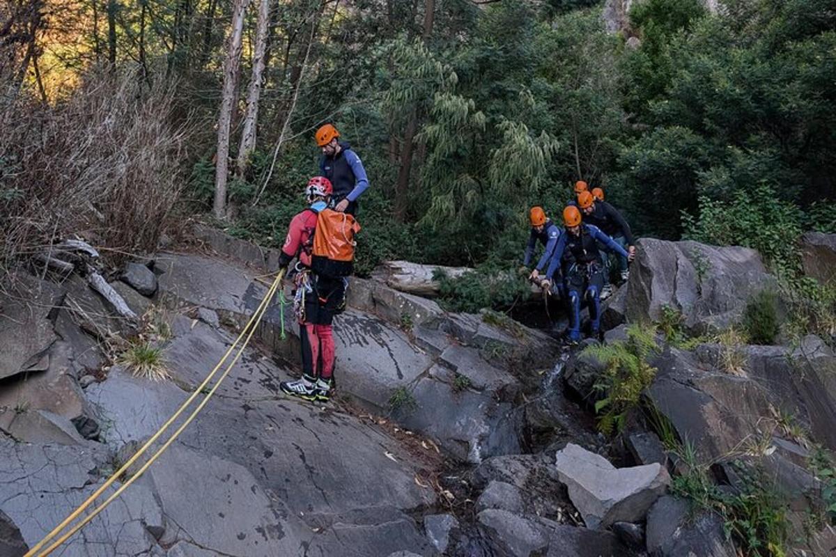 a group of people walking on a rocky trail