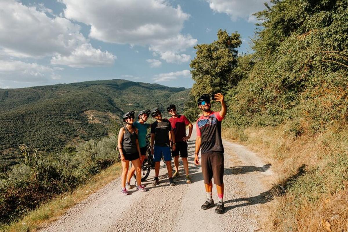 a group of people standing on a dirt road
