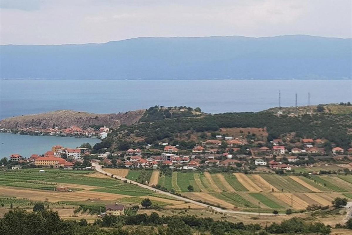 a small town on a hill next to the water
