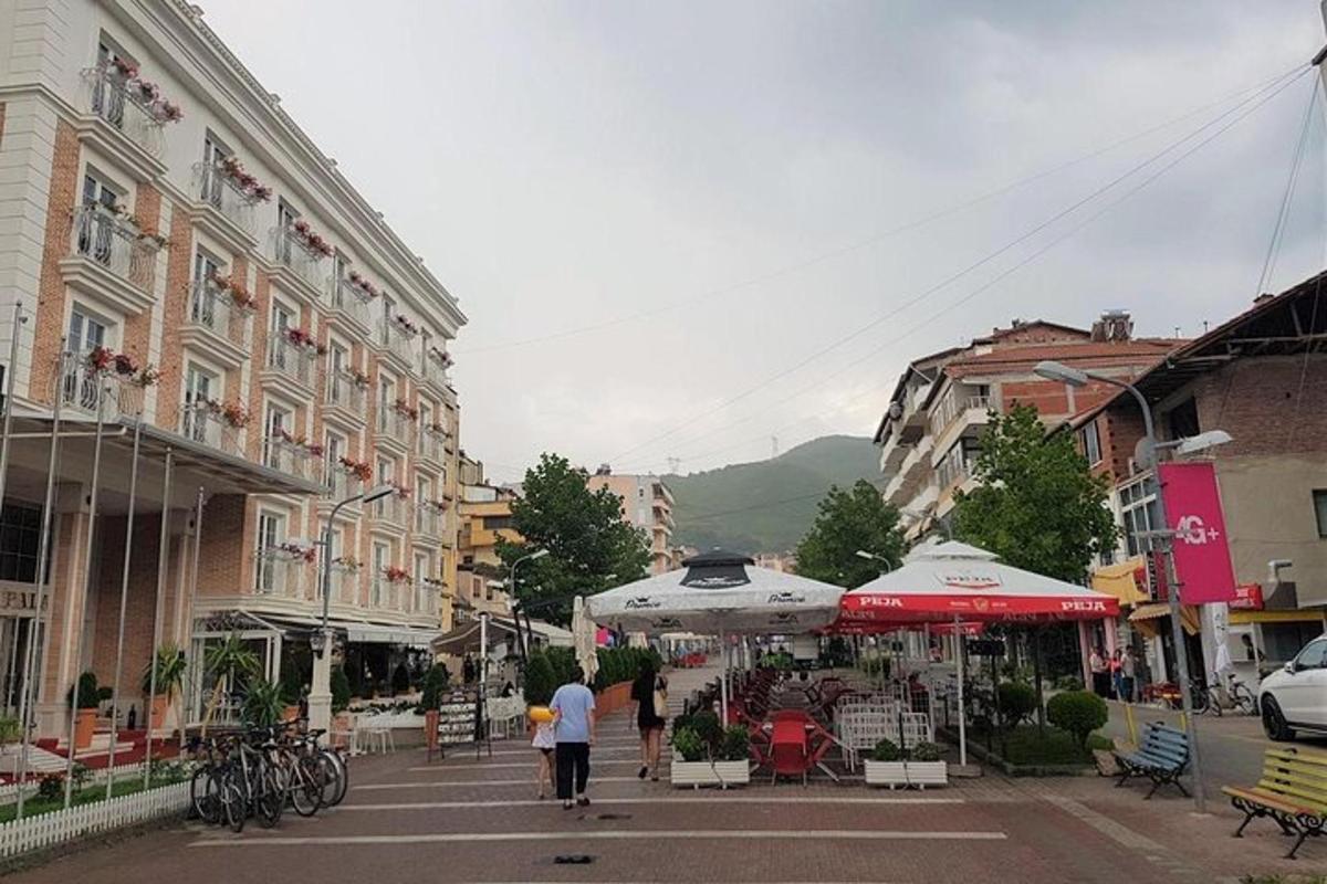 a group of people walking down a city street with umbrellas