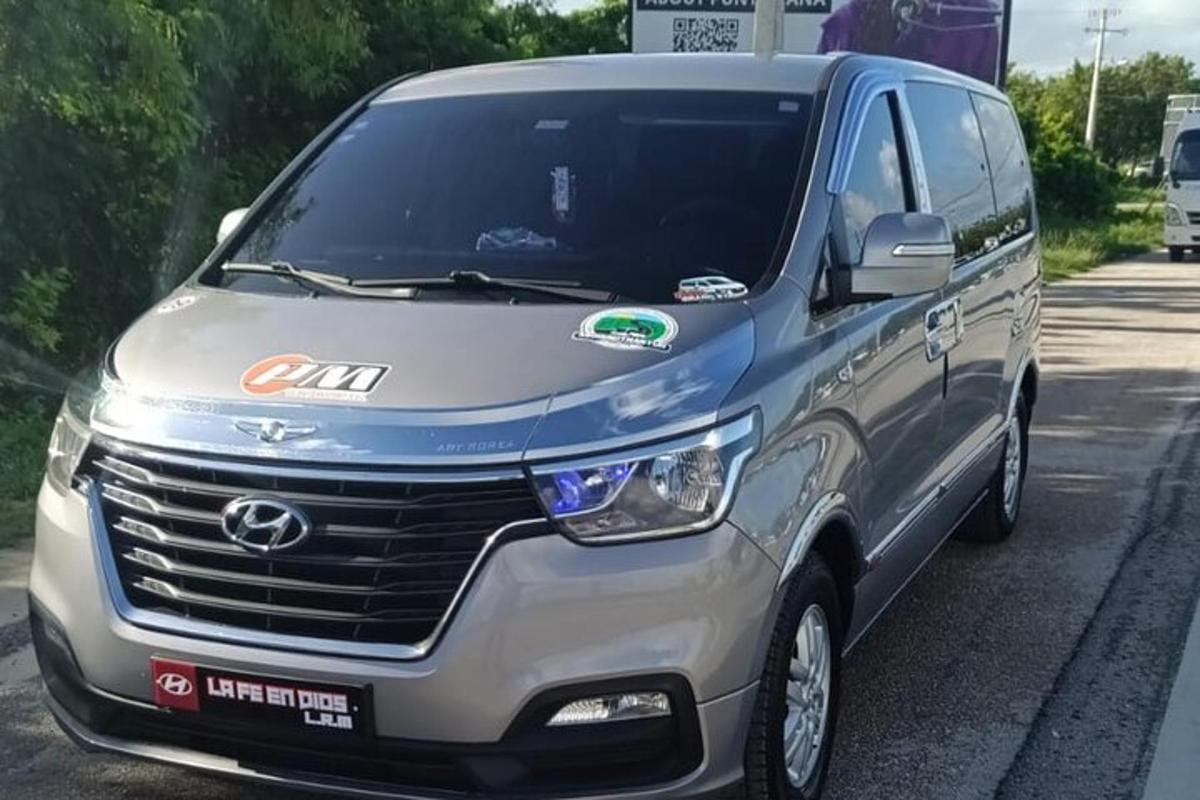 a silver hyundai van parked on a street