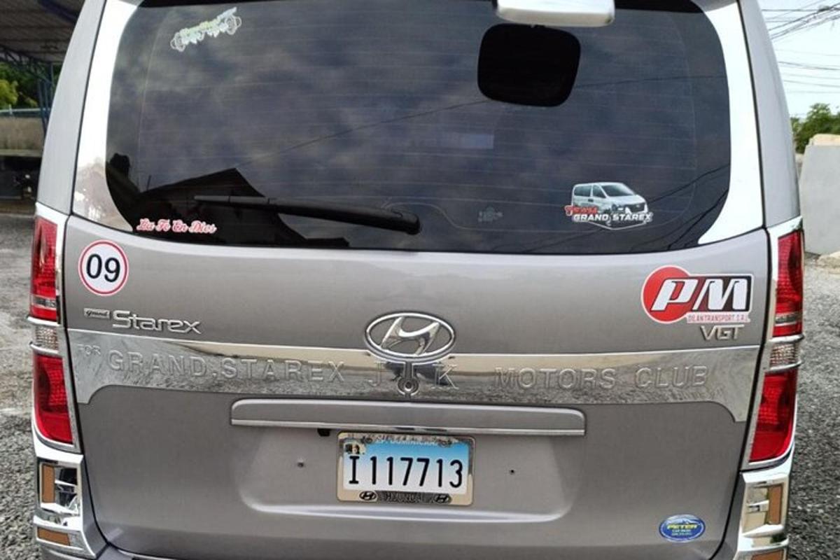 a rear view of a silver car parked in a parking lot