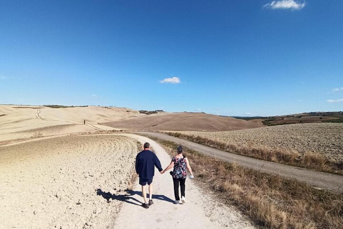 un home i una dona caminant per un camí de terra