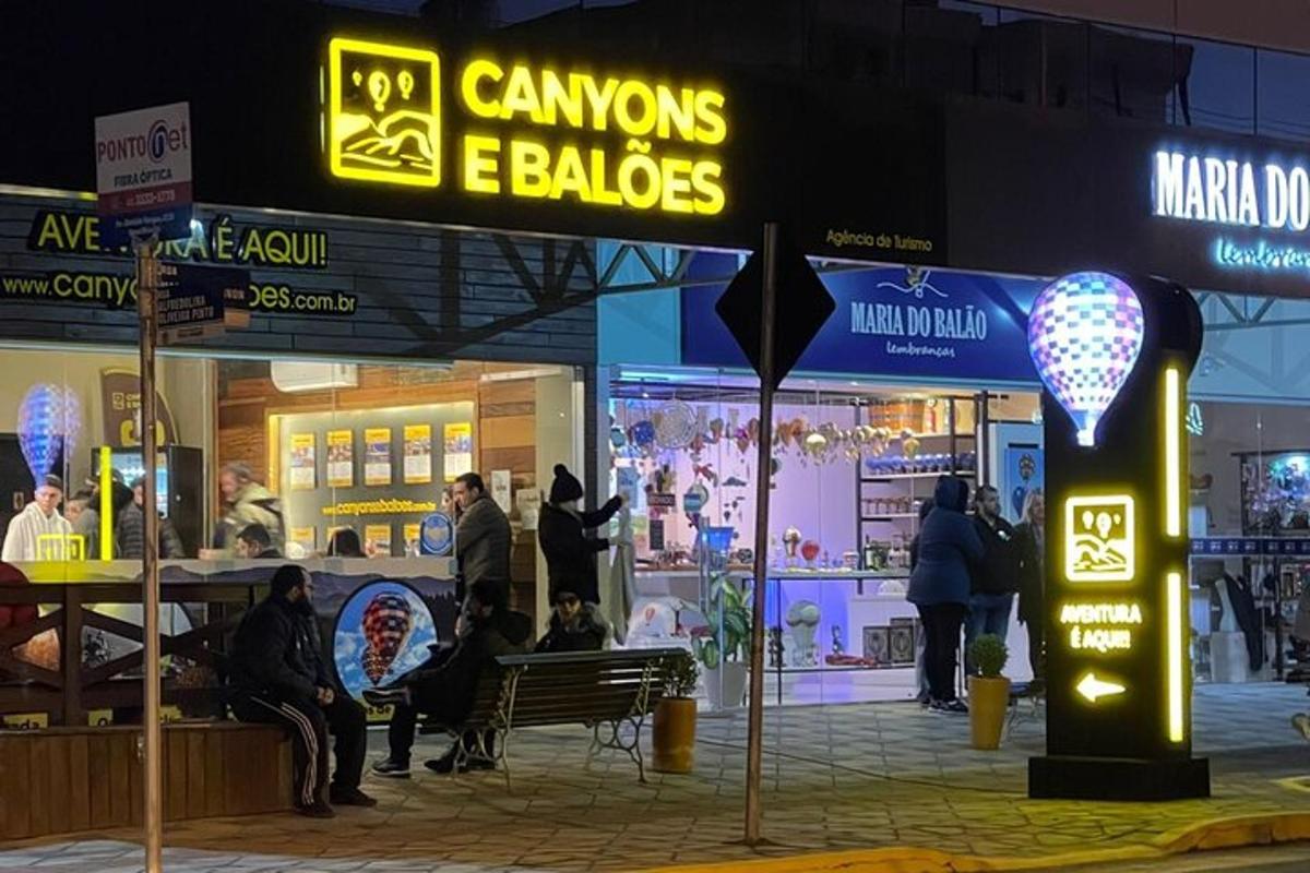 a group of people sitting outside a store at night