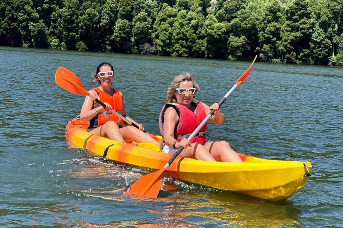 two women in a yellow kayak on a lake