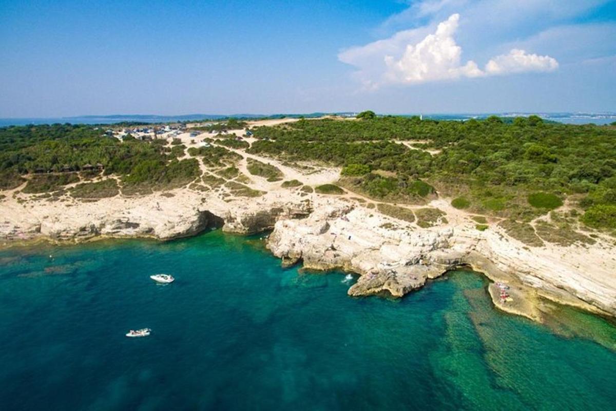 an aerial view of a beach with boats in the water
