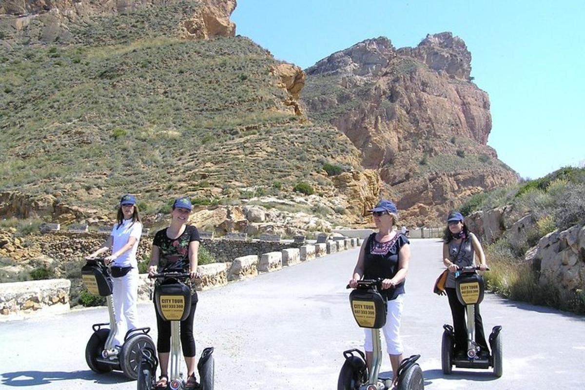 drei Frauen fahren auf Segways eine Bergstraße hinunter