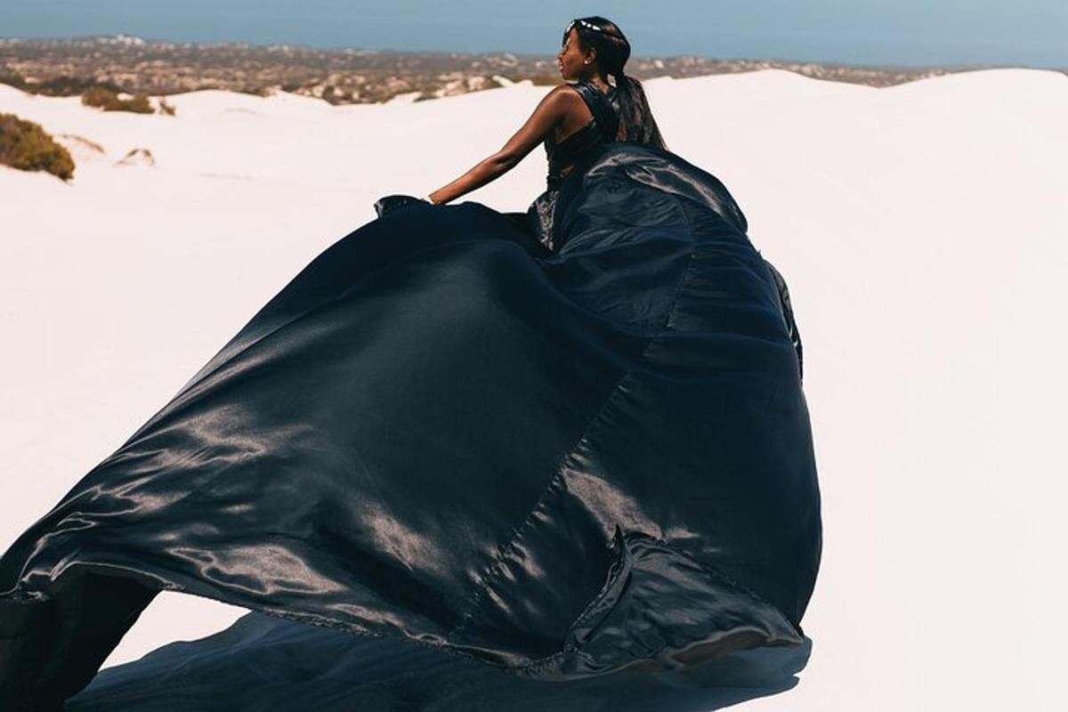 a woman standing in the snow holding a large blackigma