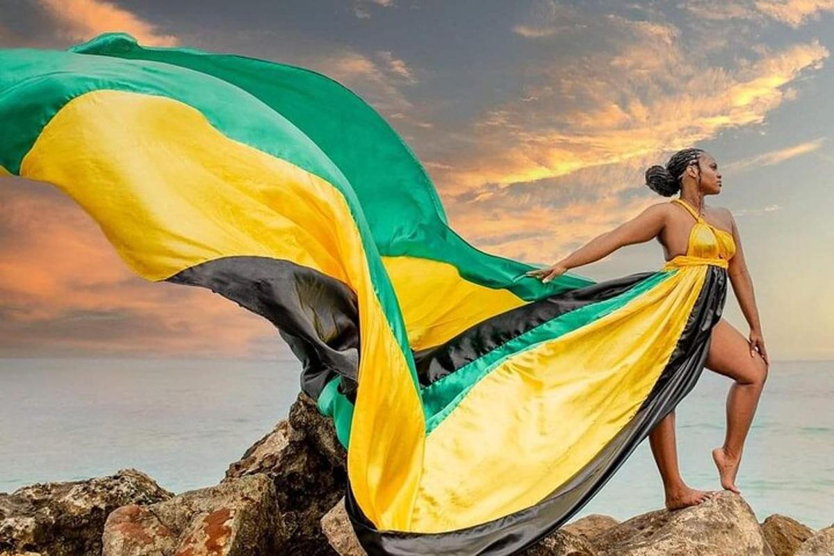 a woman in a yellow and green dress on the beach