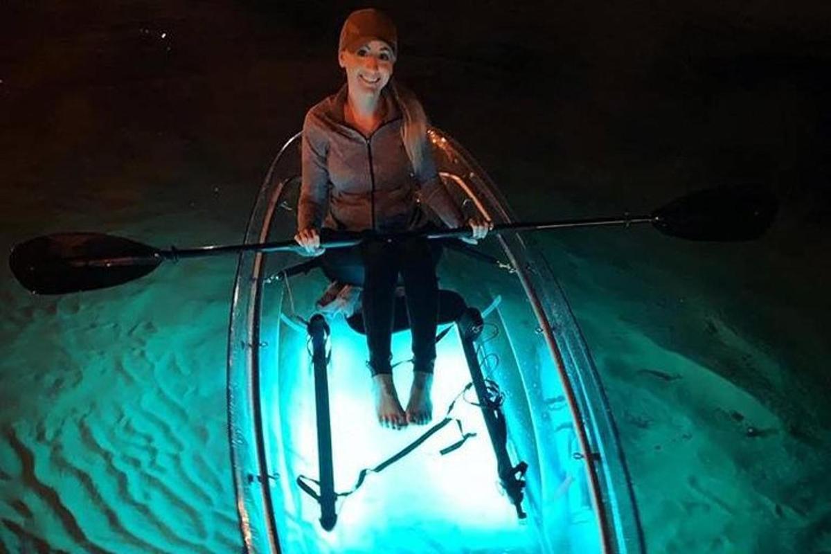a man is sitting in a kayak in the water