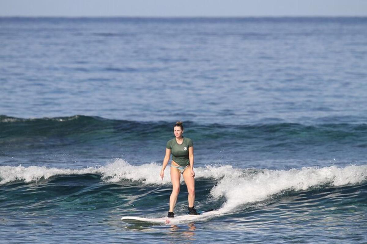 a woman riding a wave on a surfboard in the ocean