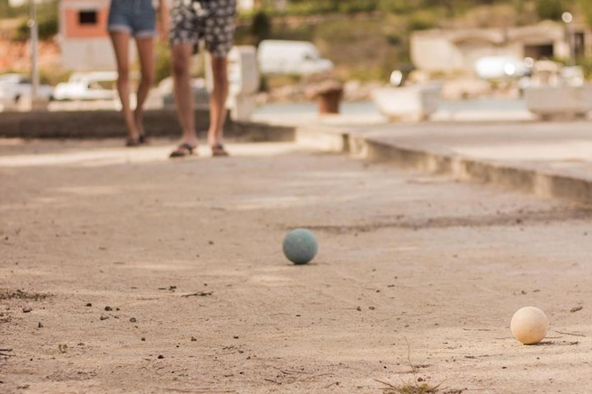 two balls on the ground with a person in the background
