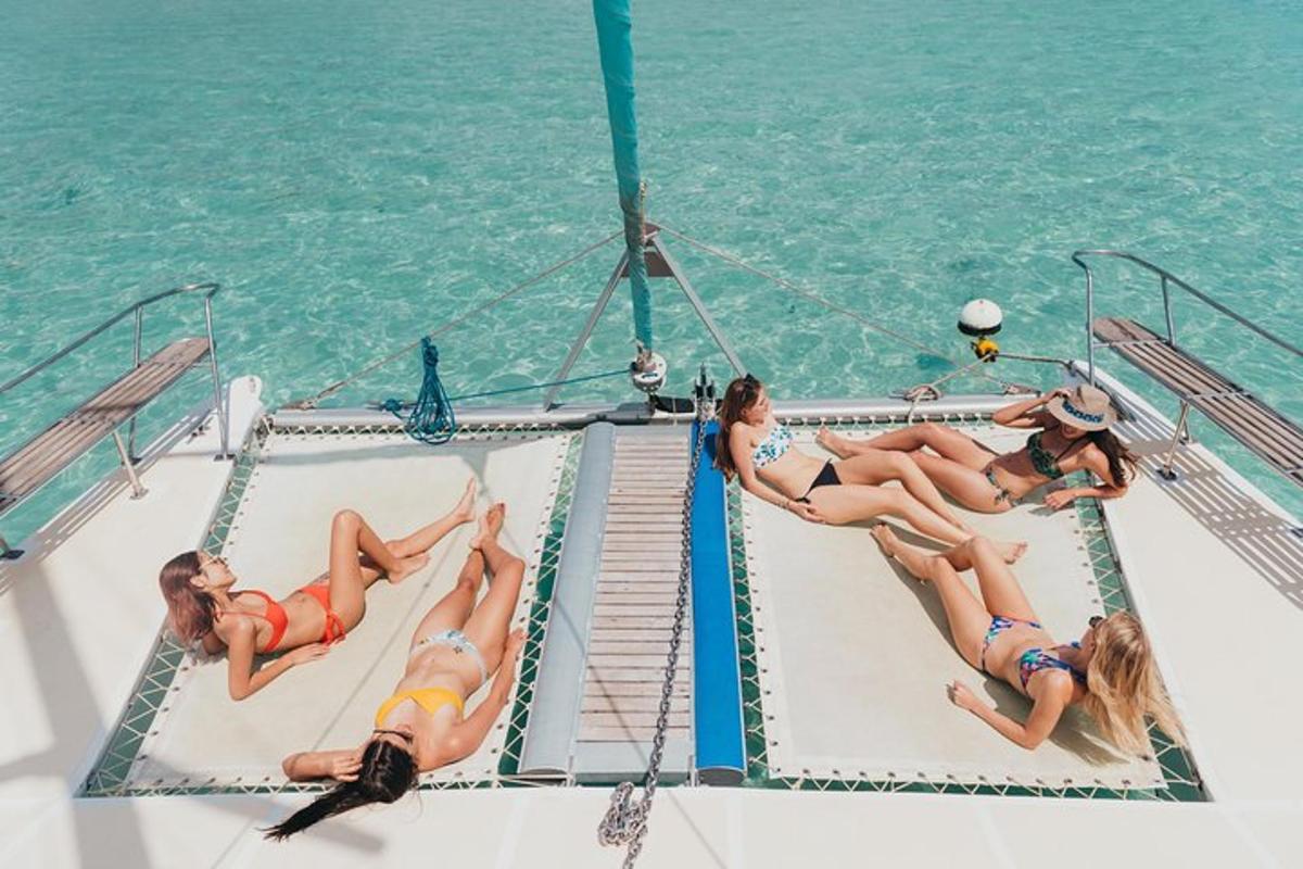 a group of women laying on the deck of a boat