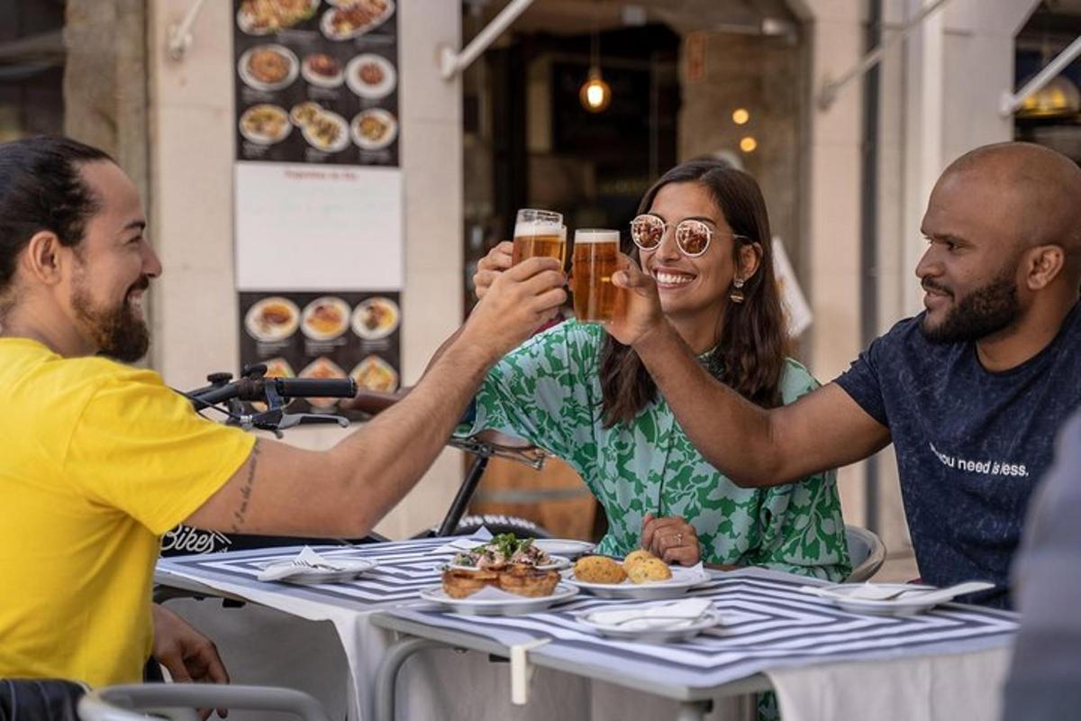 a group of people sitting at a table drinking beer