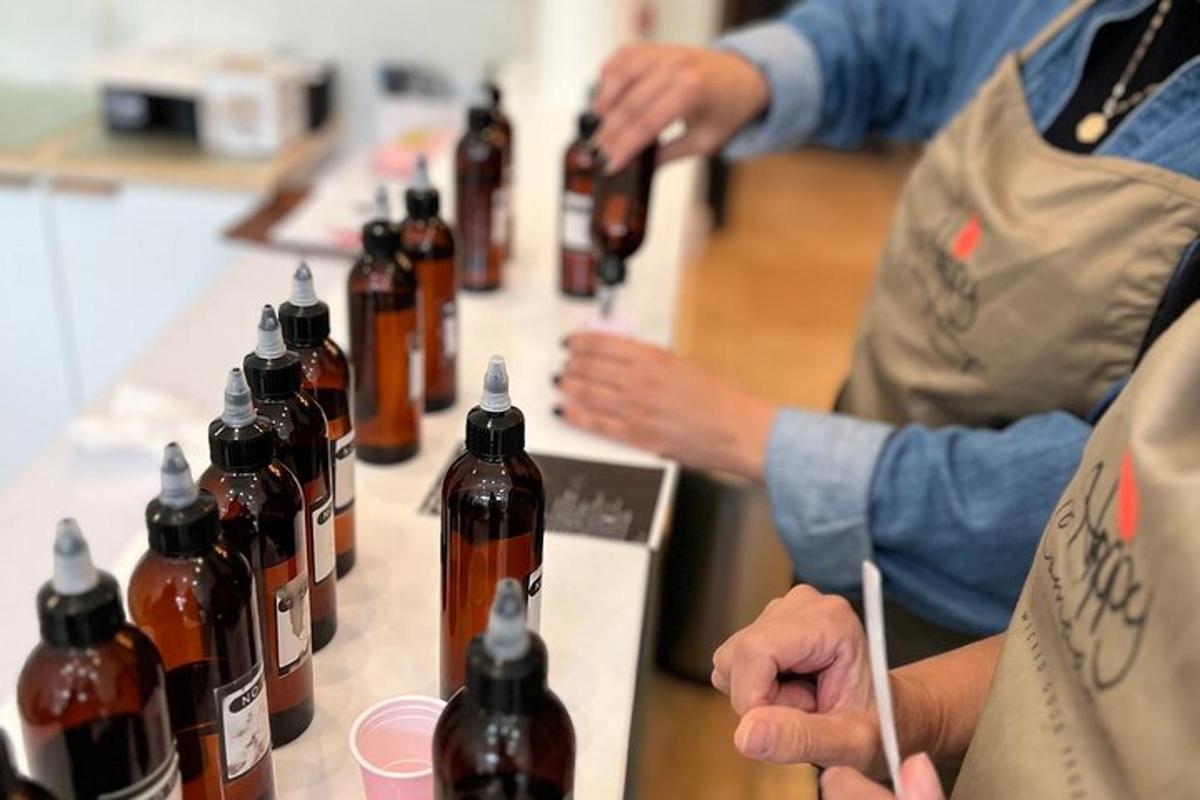 a group of people standing around a table with bottles