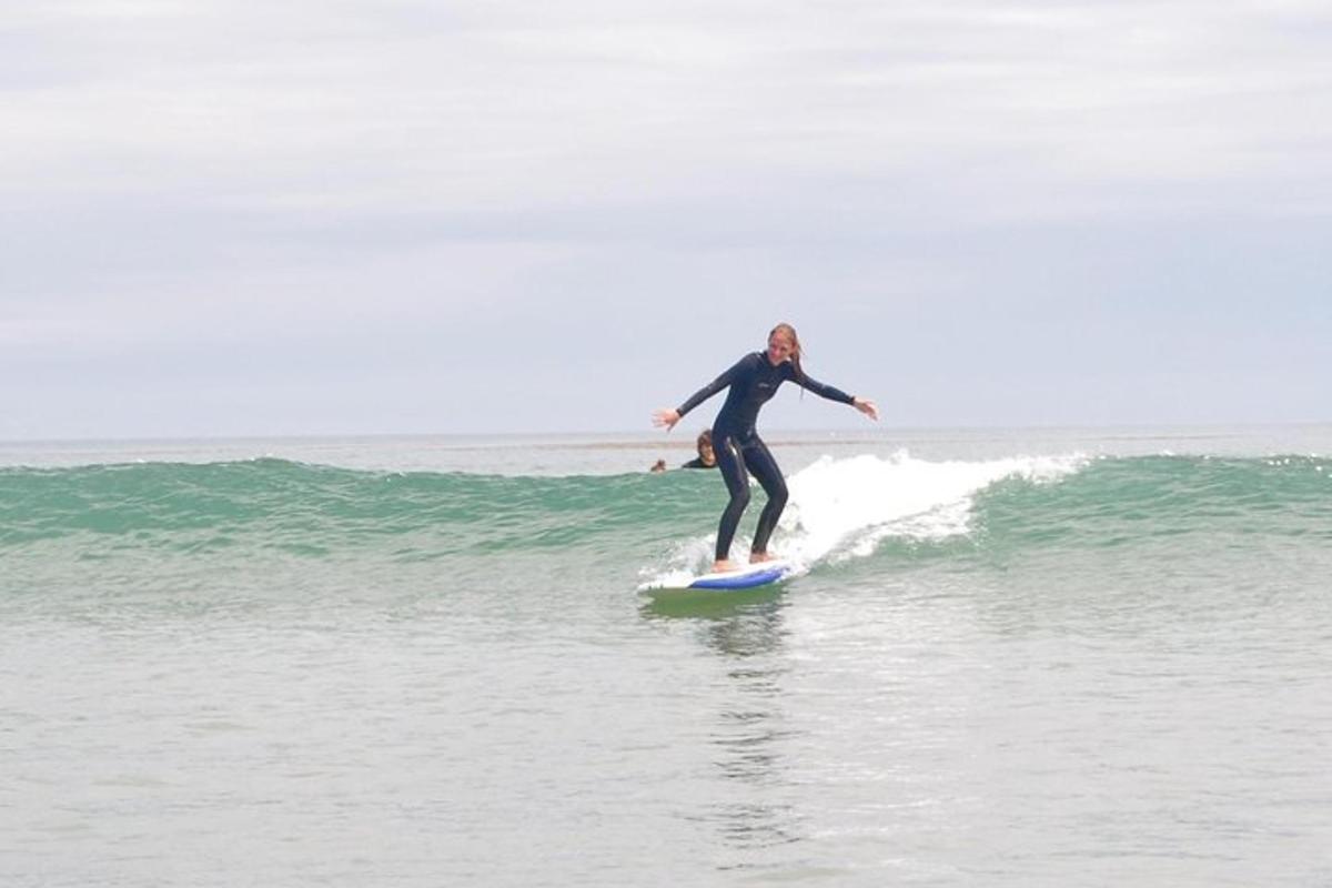 mężczyzna jadący na desce surfingowej na fali w oceanie