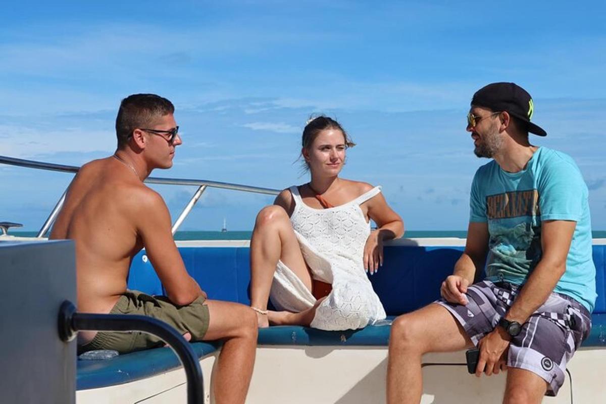 a group of three people sitting on a boat
