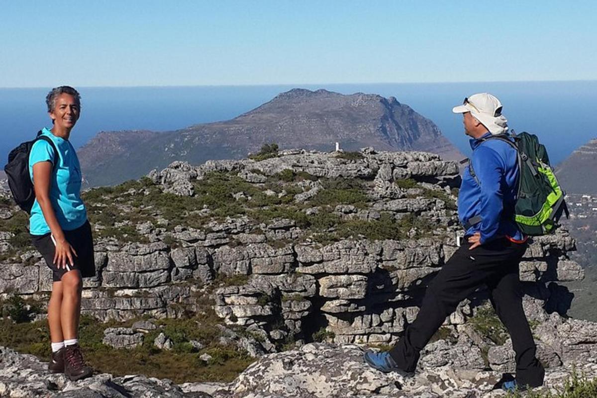 tveir menn standa á fjallstindi