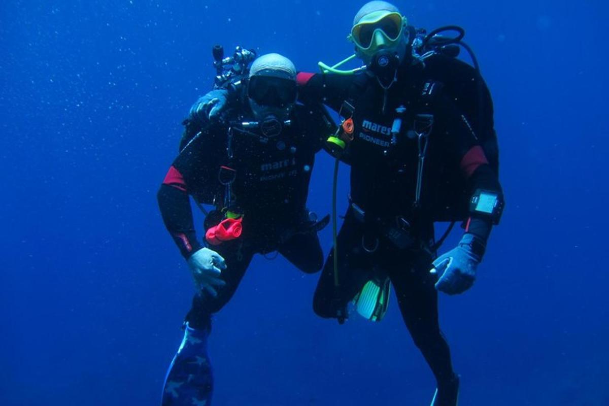 two scuba divers are posing for a picture in the water
