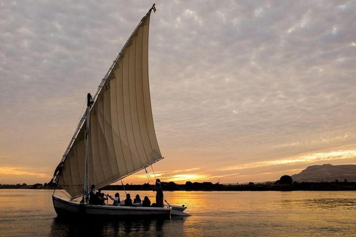 a group of people on a sail boat in the water
