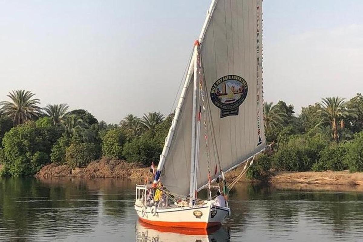 a sailboat is on the water on a river