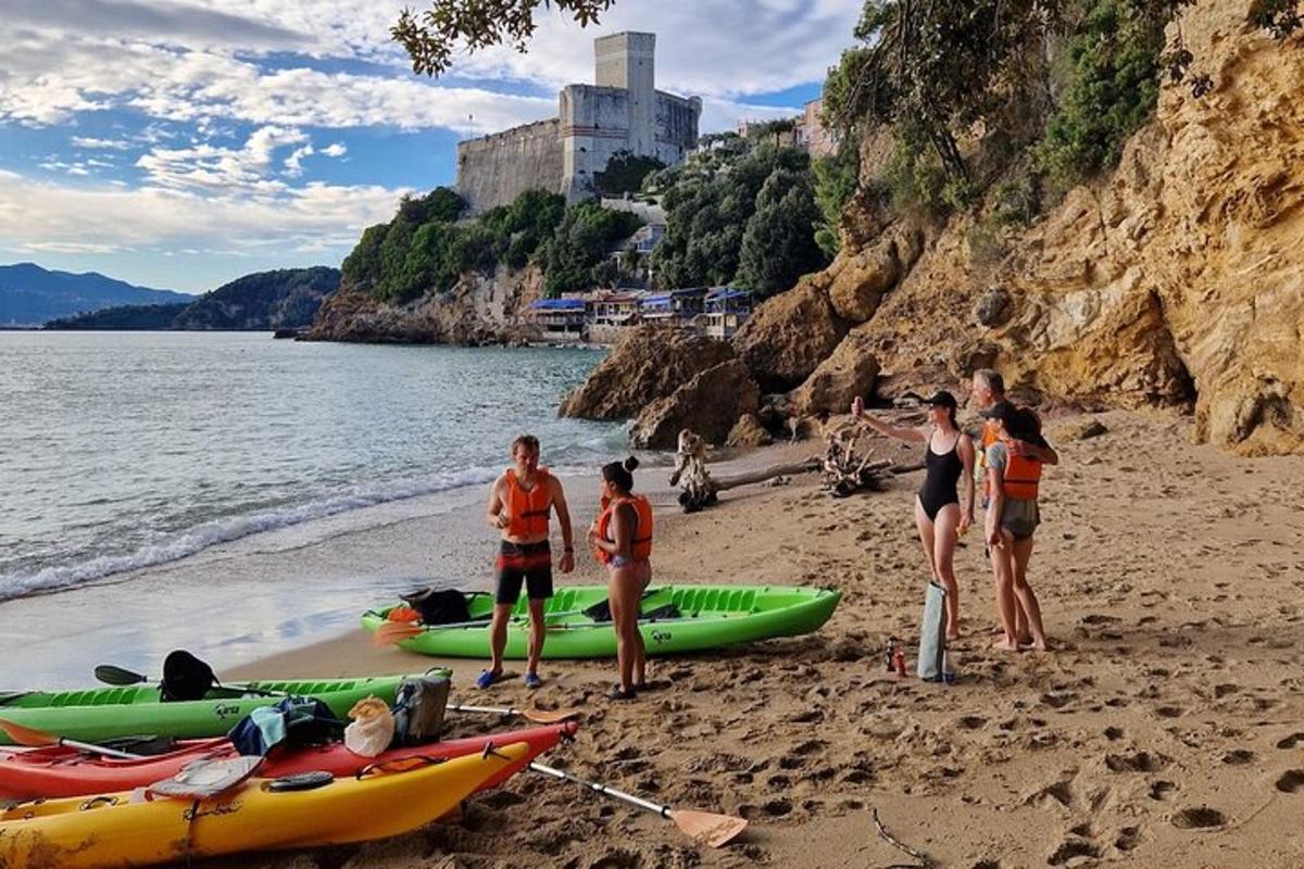 un gruppo di persone in piedi su una spiaggia con i kayak