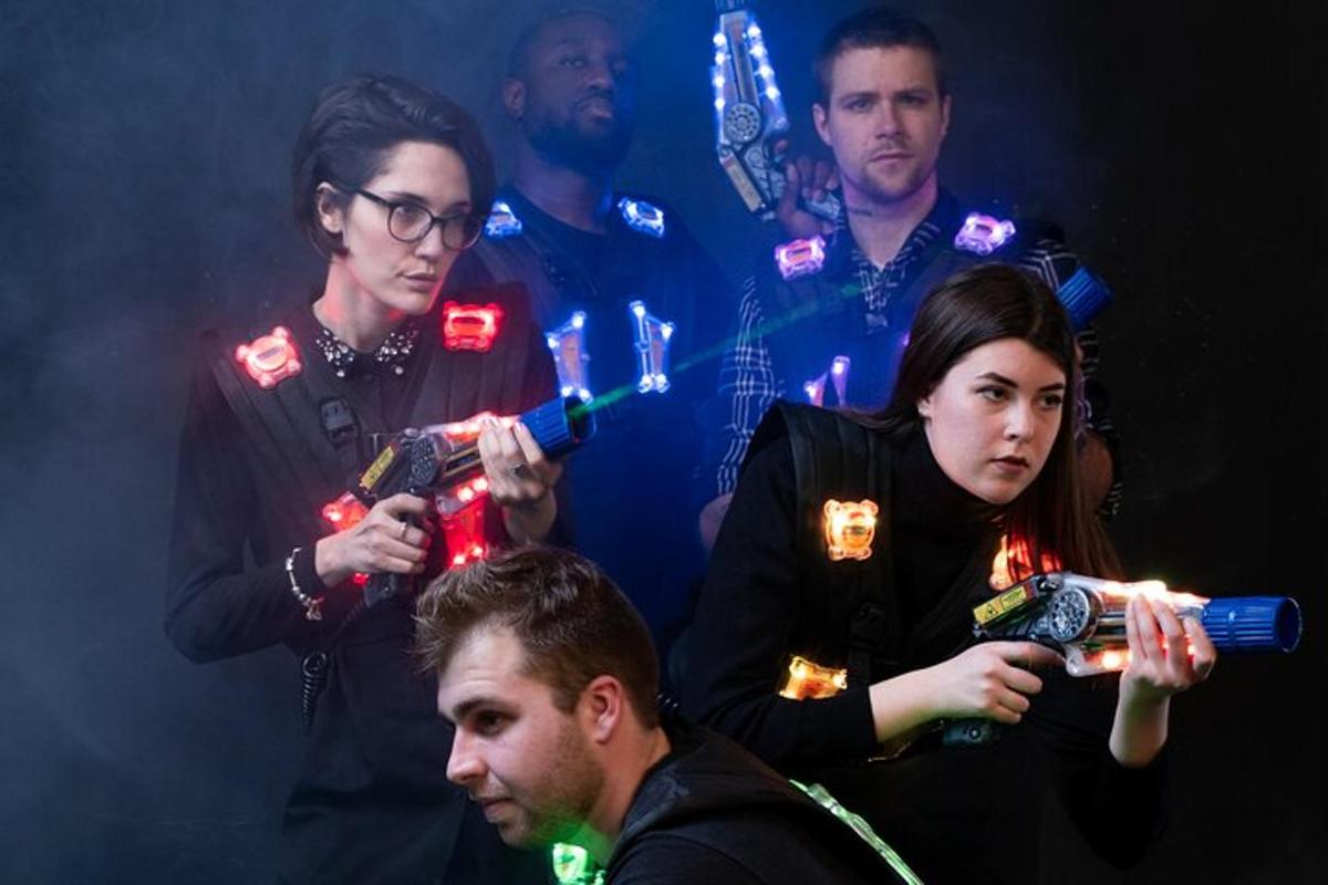 a group of people standing around a woman holding a gun