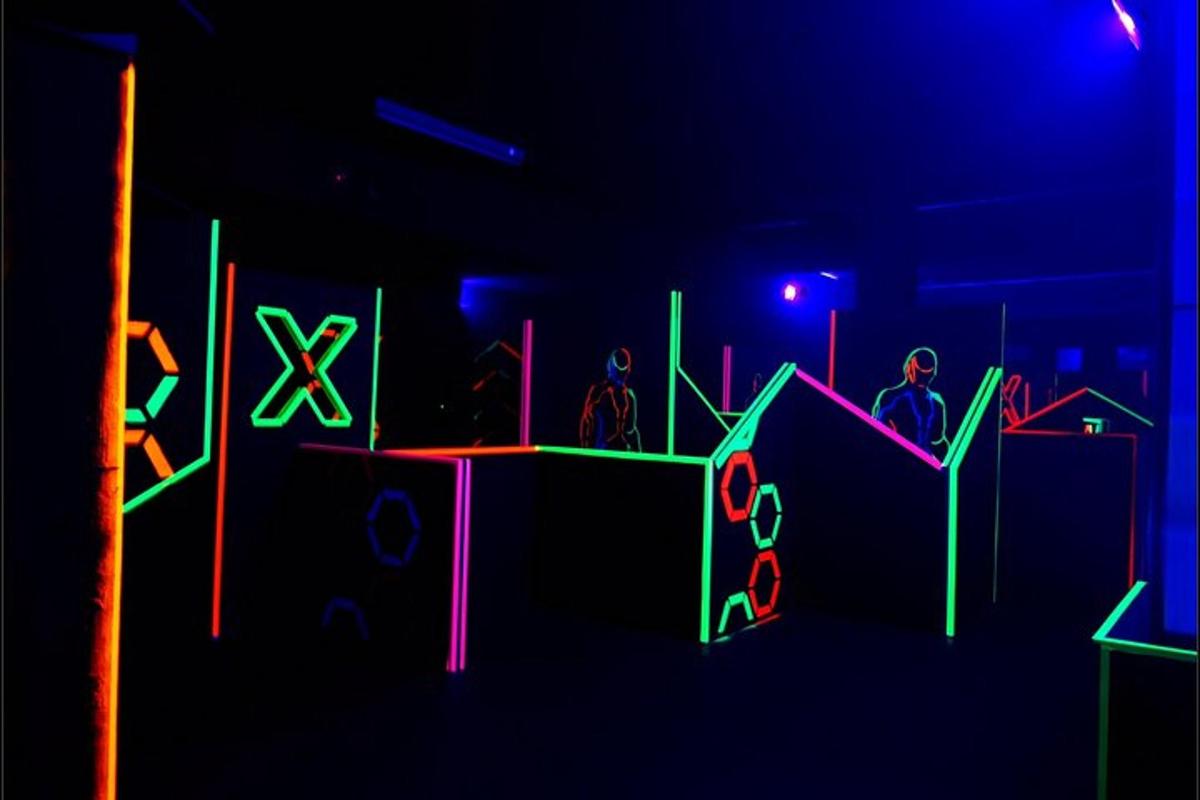 a group of people in a dark room with neon lights