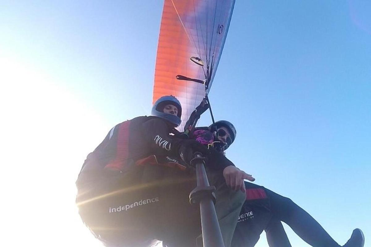 two people are riding on a windsurfing parachute