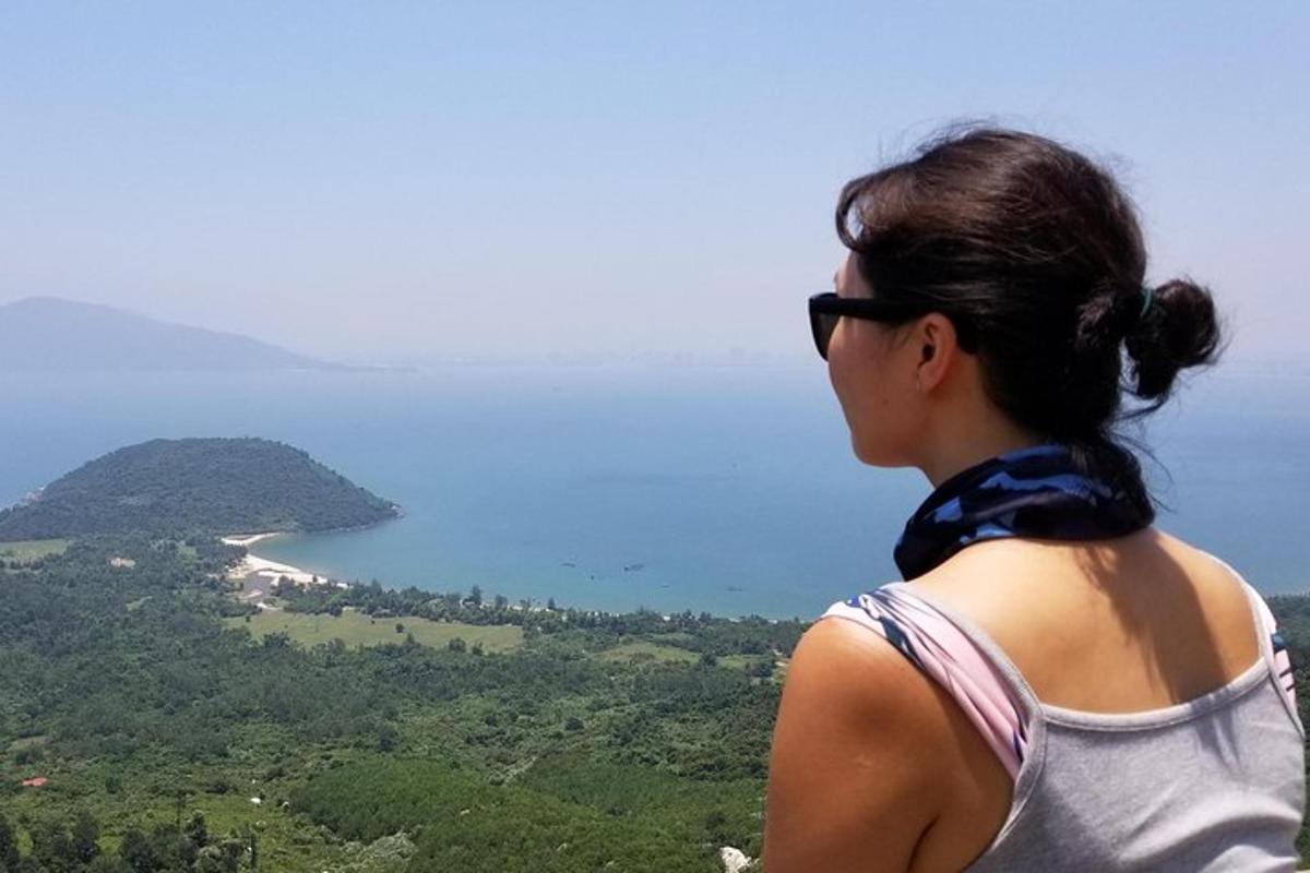 a woman is looking out at the ocean