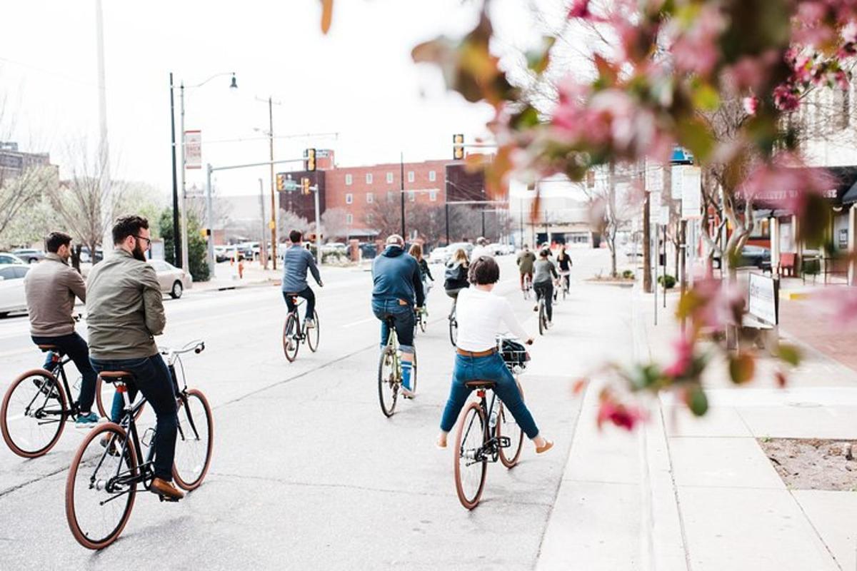 a group of people riding bikes down a street