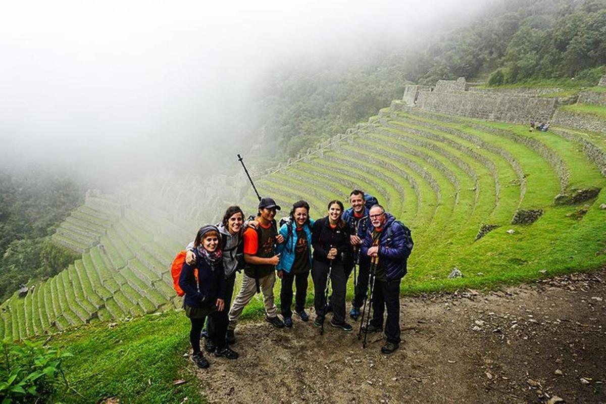 a group of people standing on the side of a mountain