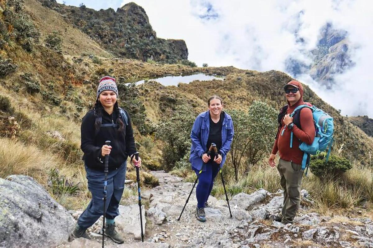 a group of three people hiking on a mountain