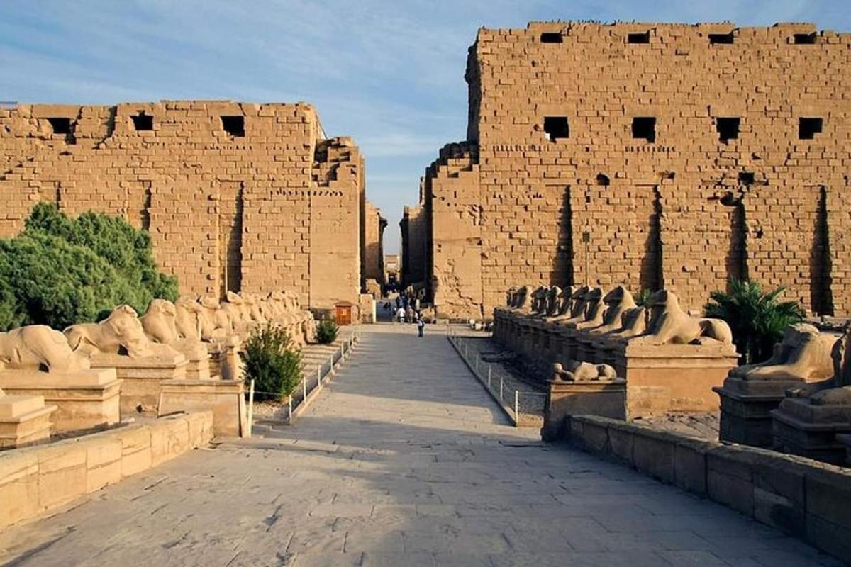 a large brick building with statues in front of it