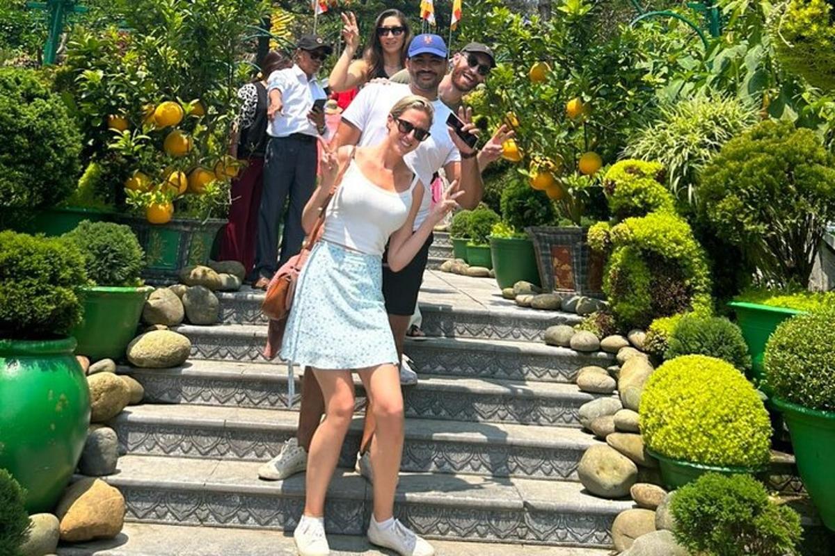 Un grupo de personas de pie en los escalones de un jardín.