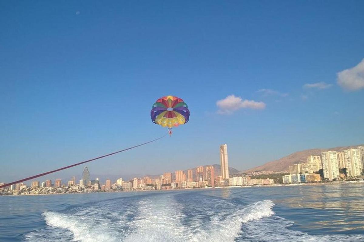 a kite flying in the sky over the water