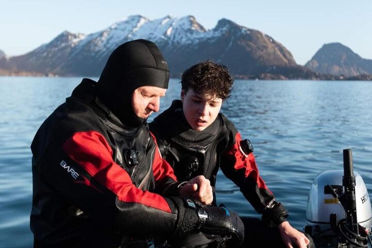 two men sitting on a boat in the water