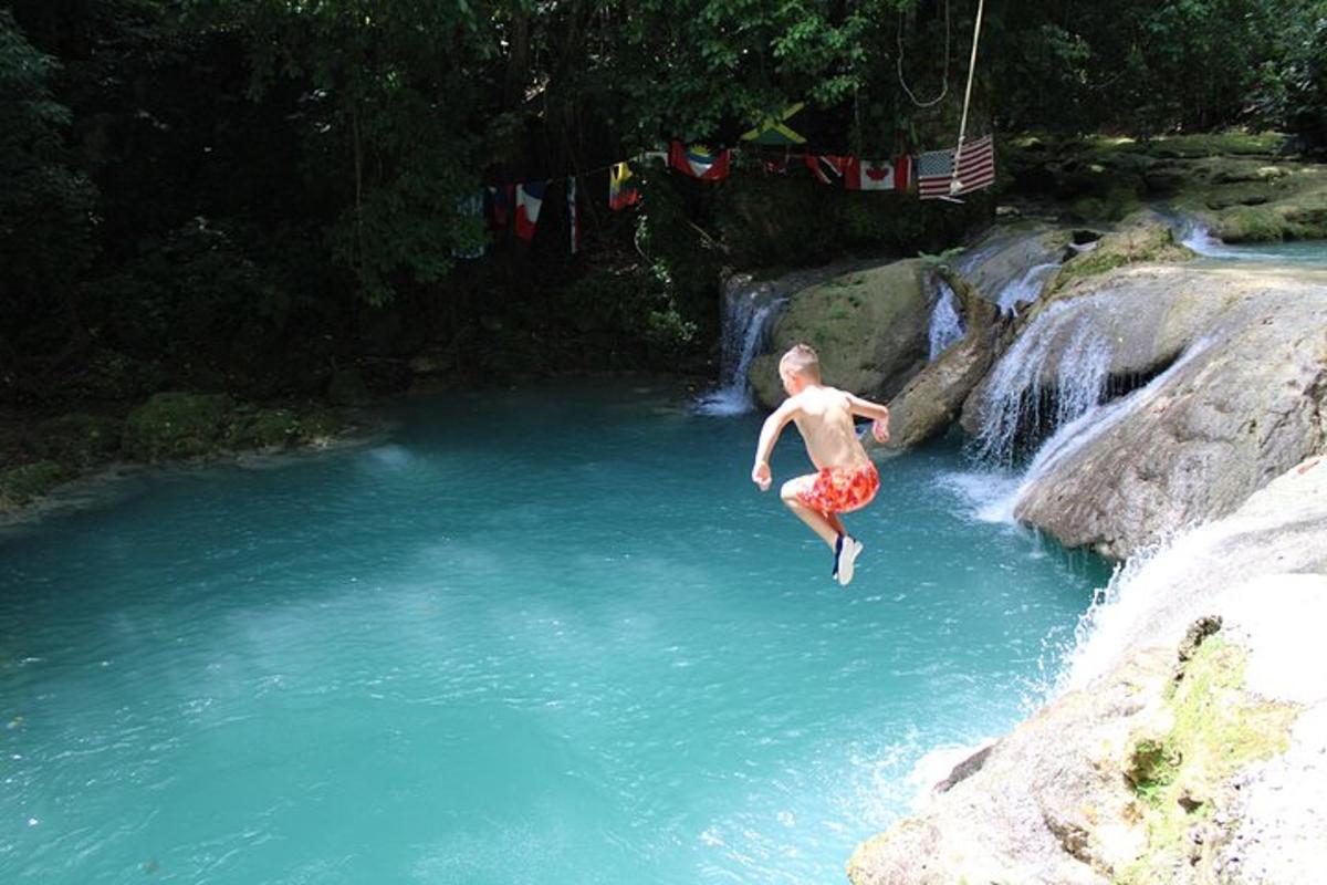 a man jumping into a pool of water in a river